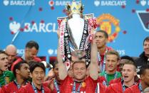 Manchester United's English striker Wayne Rooney lifts the Premier League trophy after the English Premier League football match between Manchester United and Swansea City at Old Trafford in Manchester, northwest England, on May 12, 2013. Outgoing Manchester United manager Alex Ferguson confirmed on Sunday that striker Wayne Rooney has asked to leave the club for the second time in three years