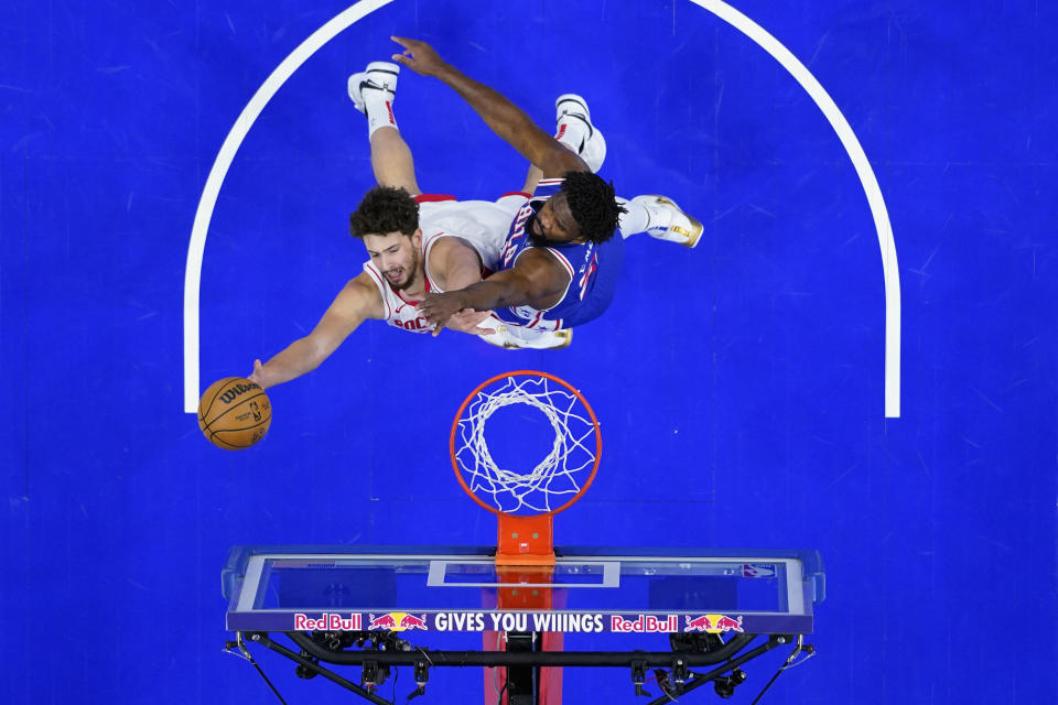 Houston Rockets' Alperen Sengun, left, goes up for a shot against Philadelphia 76ers' Joel Embiid during the first half of an NBA basketball game, Monday, Jan. 15, 2024, in Philadelphia. (AP Photo/Matt Slocum)