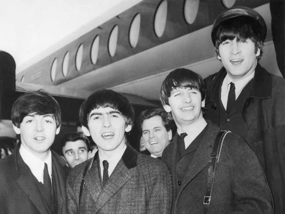 The Beatles: (left to right) Paul McCartney; George Harrison, Ringo Starr, and John Lennon on their arrival in 1964 at Heathrow Airport from Paris where they appeared at the Olympia Music Hall.