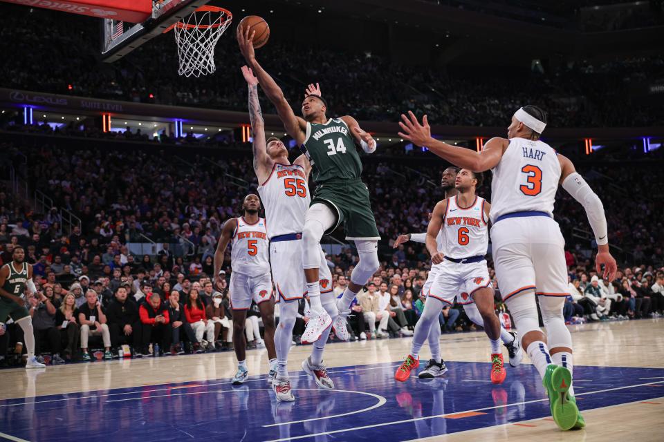 Dec 25, 2023; New York, New York, USA; Milwaukee Bucks forward Giannis Antetokounmpo (34) drives to the basket asNew York Knicks center Isaiah Hartenstein (55) and guard Quentin Grimes (6) defend during the second half at Madison Square Garden. Mandatory Credit: Vincent Carchietta-USA TODAY Sports