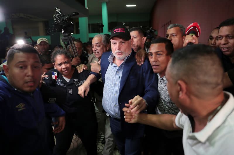 FILE PHOTO: Panama's former president Ricardo Martinelli is escorted by police officers and supporters while leaving a courthouse after being declared not guilty of spying charges in Panama City