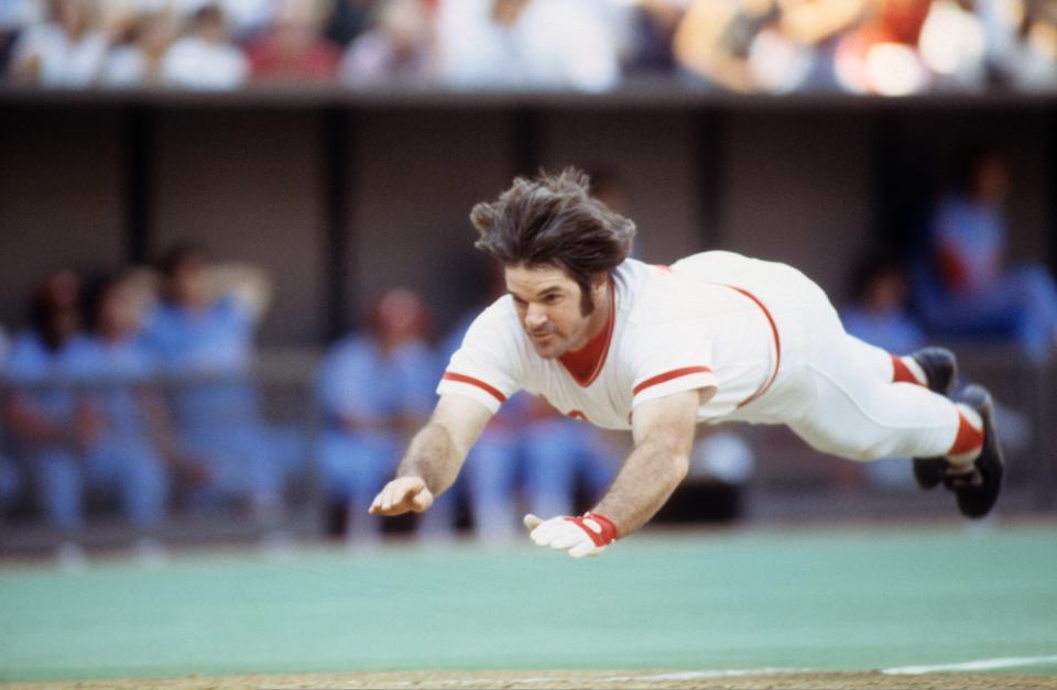 Pete Rose slides head first into home plate in a Reds game vs Philadelphia Phillies at Riverfront Stadium, Cincinnati, OH July 21, 1978. 