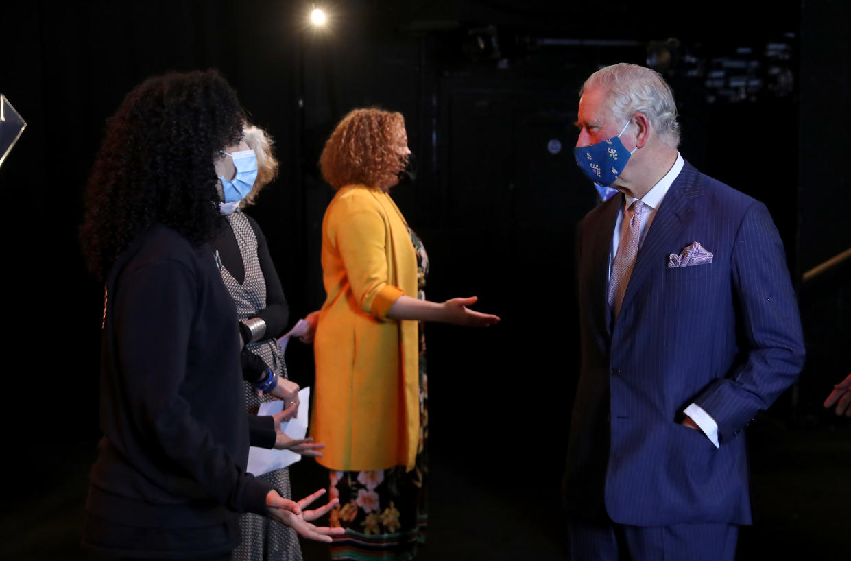 LONDON, ENGLAND - DECEMBER 03: Prince Charles, Prince of Wales (R) wears a face mask as he speaks to a performer during his visit to Soho Theatre with Camilla, Duchess of Cornwall  to celebrate London's night economy on December 03, 2020 in London, England. (Photo by Chris Jackson - WPA Pool/Getty Images)