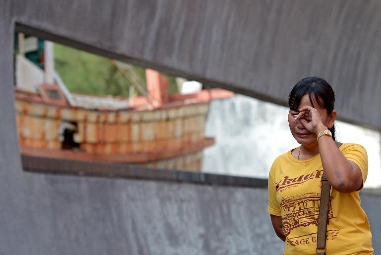 A Thai relative of a tsunami victim cries as she visits the Ban Nam Khem tsunami memorial park wall on the tenth anniversary of the 2004 tsunami in Phang-nga province on December 26, 2014