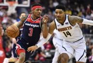 Mar 21, 2019; Washington, DC, USA; Washington Wizards guard Bradley Beal (3) dribbles as Denver Nuggets guard Gary Harris (14) defends during the second half at Capital One Arena. Mandatory Credit: Brad Mills-USA TODAY Sports