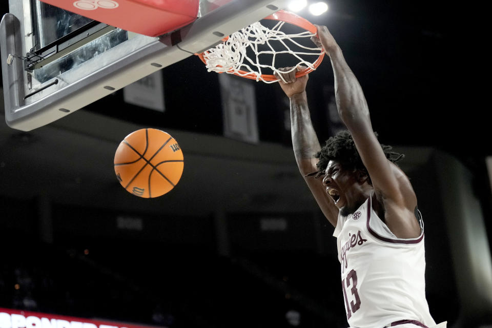 Texas A&M forward Solomon Washington (13) dunks the ball against Texas A&M Commerce during the first half of an NCAA college basketball game Monday, Nov. 6, 2023, in College Station, Texas. (AP Photo/Sam Craft)