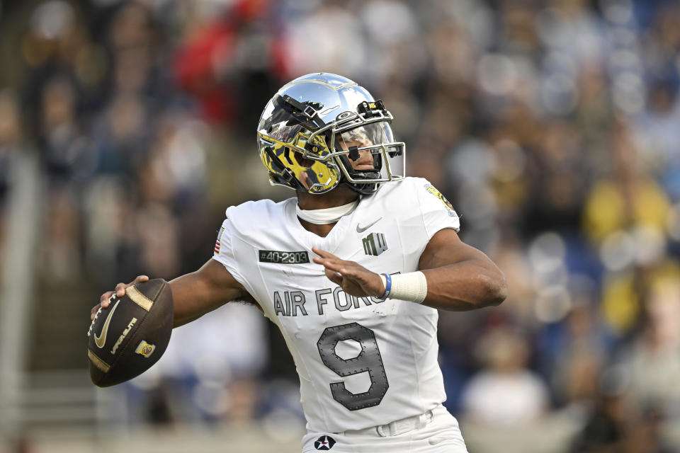 Air Force quarterback Zac Larrier (9) throws a touchdown to wide receiver Dane Kinamon, not pictured, during the first half of an NCAA college football game against Navy, Saturday, Oct. 21, 2023, in Annapolis, Md. (AP Photo/Terrance Williams)