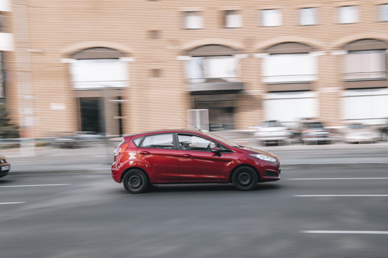 Ukraine, Kyiv - 16 July 2021: Red Ford Fiesta car moving on the street. Editorial