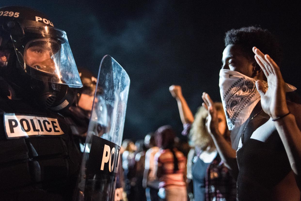 Police officers face off with protesters 