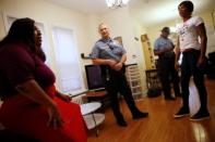 Washington Metropolitan Police Department Sergeant Jessica Hawkins (C), a transgender woman who leads the department's lesbian, gay, bisexual and transgender (LGBT) unit, speaks with transgender activist Ruby Corado (L) at a home where Corado shelters transgender women of color in Washington, U.S. October 10, 2016. REUTERS/Jonathan Ernst