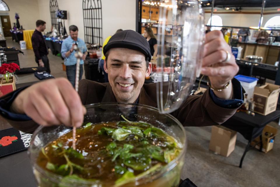 Bartender Isaac Fox helps mixes his "Aztec Julep" during the Kentucky Derby Festival's Festival Unveiled event and Four Roses mint julep competition on Wednesday evening at the Mellwood Arts Center. March 16, 2022