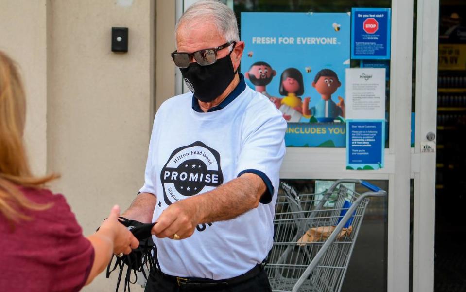 Hilton Head Island Mayor John McCann distributes free face coverings supplied by the The Hilton Head Island/Bluffton Chamber of Commerce on Saturday, June 27, 2020 at the Kroger in Shelter Cove Towne Centre on Hilton Head Island.