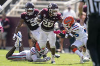 Texas A&M running back Isaiah Spiller (28) stiff arms Florida defensive back Chester Kimbrough (25) during a run during the second half of an NCAA college football game, Saturday, Oct. 10, 2020. in College Station, Texas. (AP Photo/Sam Craft)