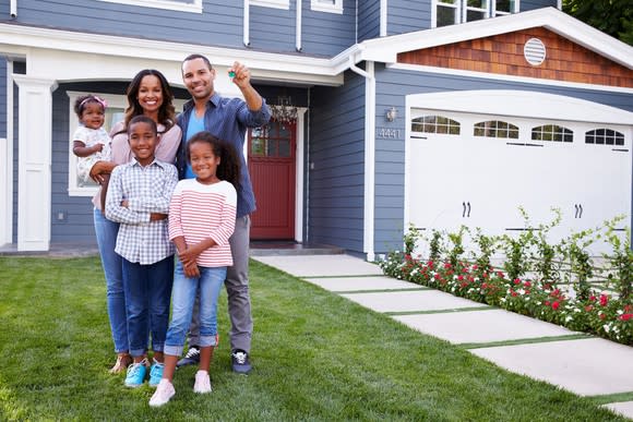 Family in front of new home.