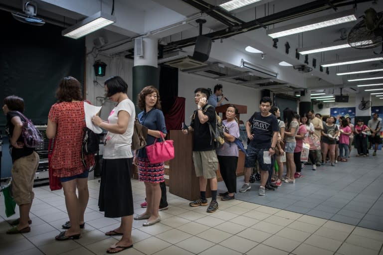 Parents queue to buy textbooks for their children on the first day of school in Hong Kong on September 1, 2015