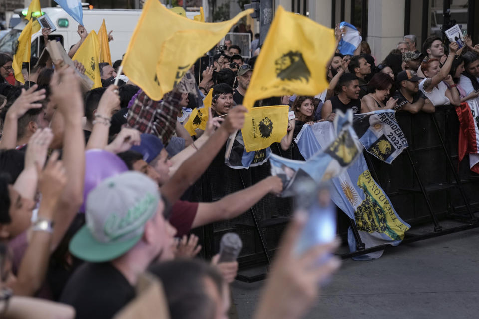 Supporters of opposition presidential candidate Javier Milei celebrate outside his campaign headquarter after polls closed in the presidential runoff election in Buenos Aires, Argentina, Sunday, Nov. 19, 2023. (AP Photo/Rodrigo Abd)