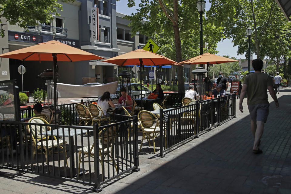 Customers of the Buckhown Grill dine outdoors on Wednesday, July 1, 2020, in Walnut Creek, Calif. California Gov. Gavin Newsom on Wednesday ordered bars and indoor dining at restaurants to close in most areas of the state for the next three weeks amid a troubling surge of new coronavirus cases throughout the state. (AP Photo/Ben Margot)