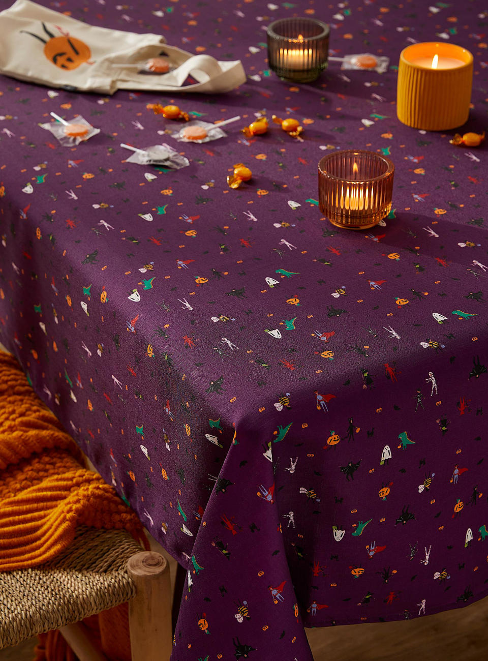 the tablecloth on a table with candles and candy