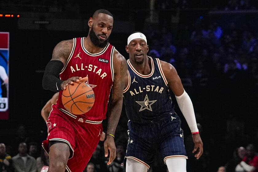 Los Angeles Lakers forward LeBron James (23) drives past Miami Heat center Bam Adebayo.