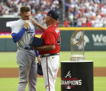 Atlanta Braves manager Brian Snitker, right, presents former Braves first baseman Freddie Freeman with his World Series Championship ring during Freeman's return to Atlanta with the Los Angles Dodgers for a baseball game Friday, June 24, 2022, in Atlanta. (Curtis Compton/Atlanta Journal-Constitution via AP)