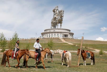 People ride horses for tourists visiting the Genghis Khan Statue Complex, east of Ulaanbaatar