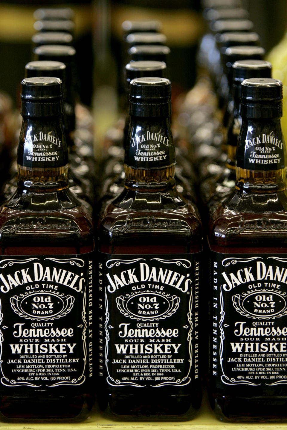 In this May 24, 2005 photo, Bottles of Jack Daniel's Tennessee Whiskey are on display at a Kansas City, Mo. liquor. If it isn't fermented in Tennessee from mash of at least 51 percent corn, aged in new charred oak barrels, filtered through maple charcoal and bottled at a minimum of 80 proof, it isn't Tennessee whiskey. So says a year-old law here that resembles almost to the letter the process used to make Jack Daniel's. Now lawmakers are looking at amending that law so that some of the craft distillers that have sprung up in recent years can label their products Tennessee whiskey, a distinctive and popular draw in the booming American liquor business. The people behind Jack Daniel's see the hand of a bigger rival at work, however, the foreign-owned conglomerate that makes George Dickel, another famed Tennessee brand. (AP Photo/Charlie Riedel)