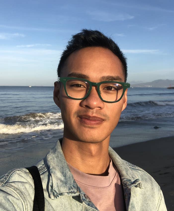 author smiling by the beach