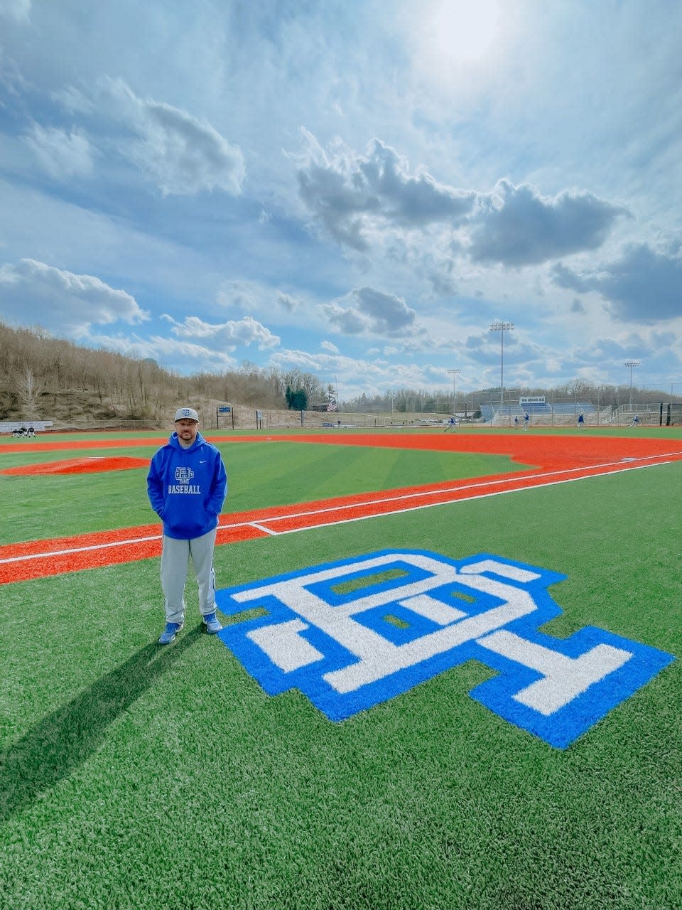 Buckeye Trail head baseball coach Cory McQuain stands on the new turf field prior to Wednesday's home opener with Strasburg. The East Guernsey School District has invested $2.6 million into upgrading their baseball, softball, football and track facilities.