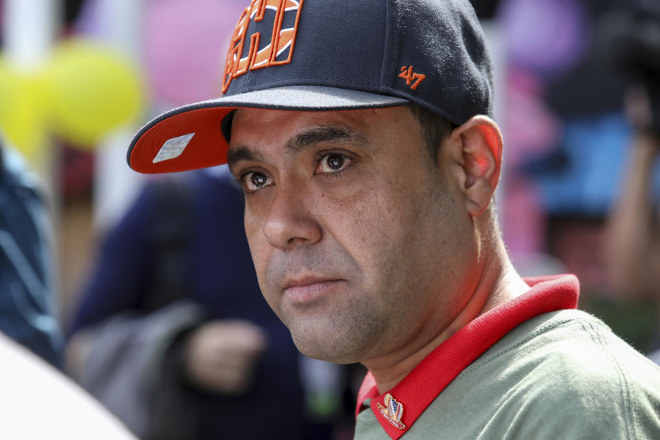 Miguel Perez Jr. listens to a supporter speaking at a news conference in Chicago on Tuesday, Sept. 24, 2019. Perez, an Army veteran who was deported to Mexico in 2018 arrived back in Chicago Tuesday for a final chance at becoming a U.S. citizen and living in the city he has called home since boyhood. (AP Photo/Teresa Crawford)