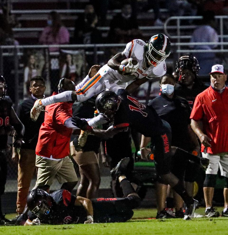 South's Syncere Trice sends Dunbar's Roger Mottley into the air as he tries to escape the tackle. Action from the Dunbar High School at South Fort Myers, Friday night, October 30, 2020, football game. 