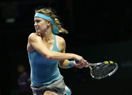 Eugenie Bouchard of Canada follows through on a return to Ana Ivanovic of Serbia during their WTA Finals singles tennis match at the Singapore Indoor Stadium October 22, 2014. REUTERS/Edgar Su