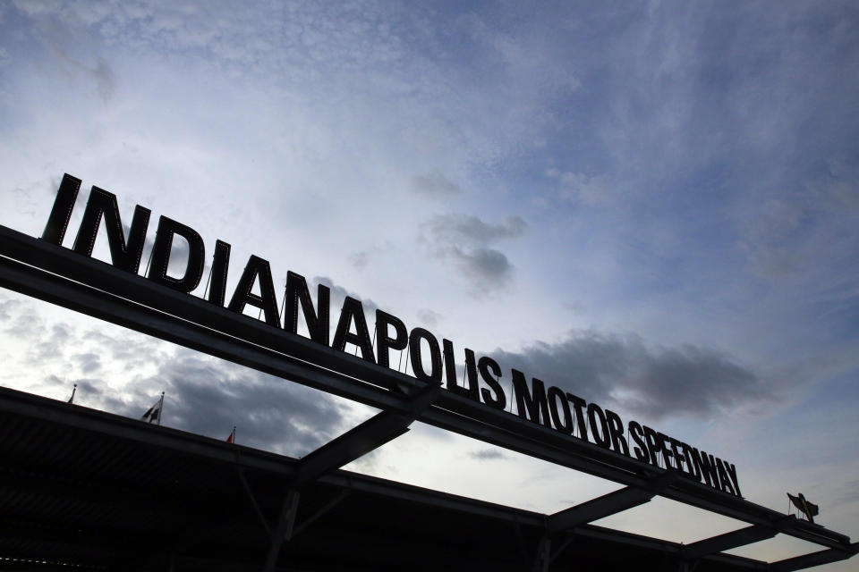 FILE - In this May 26, 2019, file photo, the sun begins to rise at the main entrance to the track before the Indianapolis 500 IndyCar auto race at Indianapolis Motor Speedway in Indianapolis. Roger Penske, at 83 and considered high risk to the coronavirus as a 2017 kidney transplant recipient, still makes the daily three-minute commute to his Bloomfield Hills, Mich, office. He works 12 or more hours a day from his conference room at Penske Corp., which has a skeleton crew all practicing social distancing. Penske also had the small matter of planning his first Indianapolis 500.(AP Photo/R Brent Smith, File)