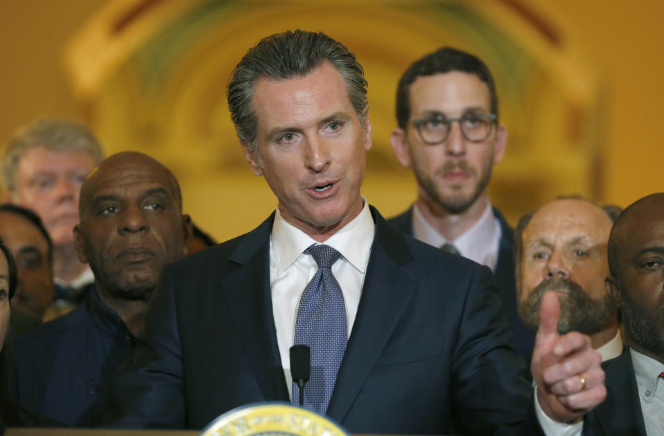 Flanked by lawmakers, Gov. Gavin Newsom discusses his decision to place a moratorium on the death penalty during a news conference at the Capitol, March 13, 2019, in Sacramento, Calif. (AP Photo/Rich Pedroncelli)