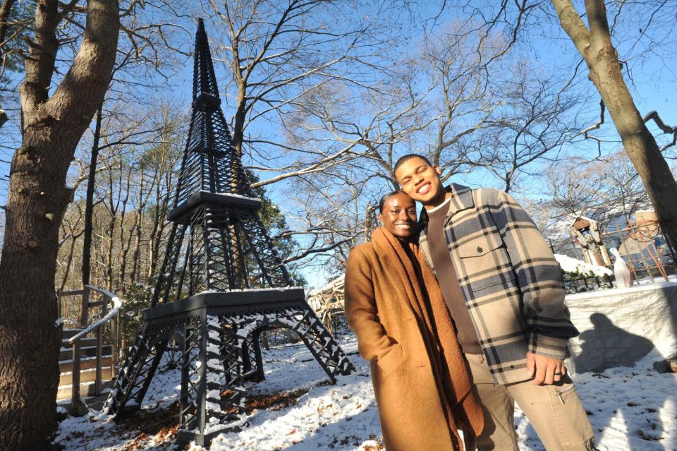 Amber Jogie, left, and her fiance, Belmiro Da Veiga, are pictured near the 24-foot replica of the Eiffel Tower built by Steve Temple in his Abington backyard in 2020.