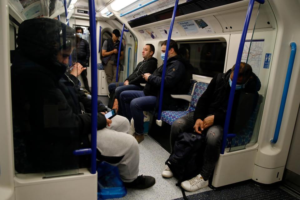 A commuter wearing PPE (personal protective equipment), including a face mask as a precautionary measure against COVID-19, travel in the morning rush hour on TfL (Transport for London) London underground Victoria Line train from Walthamstow towards central London on May 13, 2020, as people start to return to work after COVID-19 lockdown restrictions were eased. - Britain's economy shrank two percent in the first three months of the year, rocked by the fallout from the coronavirus pandemic, official data showed Wednesday, with analysts predicting even worse to come. Prime Minister Boris Johnson began this week to relax some of lockdown measures in order to help the economy, despite the rising death toll, but he has also stressed that great caution is needed. (Photo by Tolga AKMEN / AFP) (Photo by TOLGA AKMEN/AFP via Getty Images)