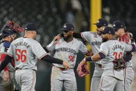 Minnesota Twins left fielder Willi Castro, center, and his teammates celebrate their 3-2 win over the Chicago White Sox during the ninth inning of a baseball game Monday, April 29, 2024, in Chicago. (AP Photo/Erin Hooley)