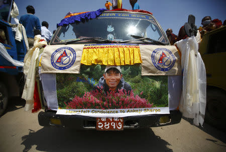 A portrait of Ankaji Sherpa, who lost his life in an avalanche in Mount Everest last Friday, is seen on a truck carrying his body during a funeral rally of Nepali Sherpa climbers in Kathmandu April 21, 2014. REUTERS/Navesh Chitrakar