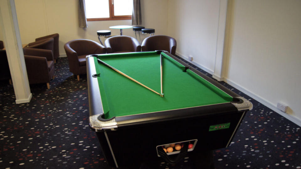 A relaxation room with a pool table. (PA)