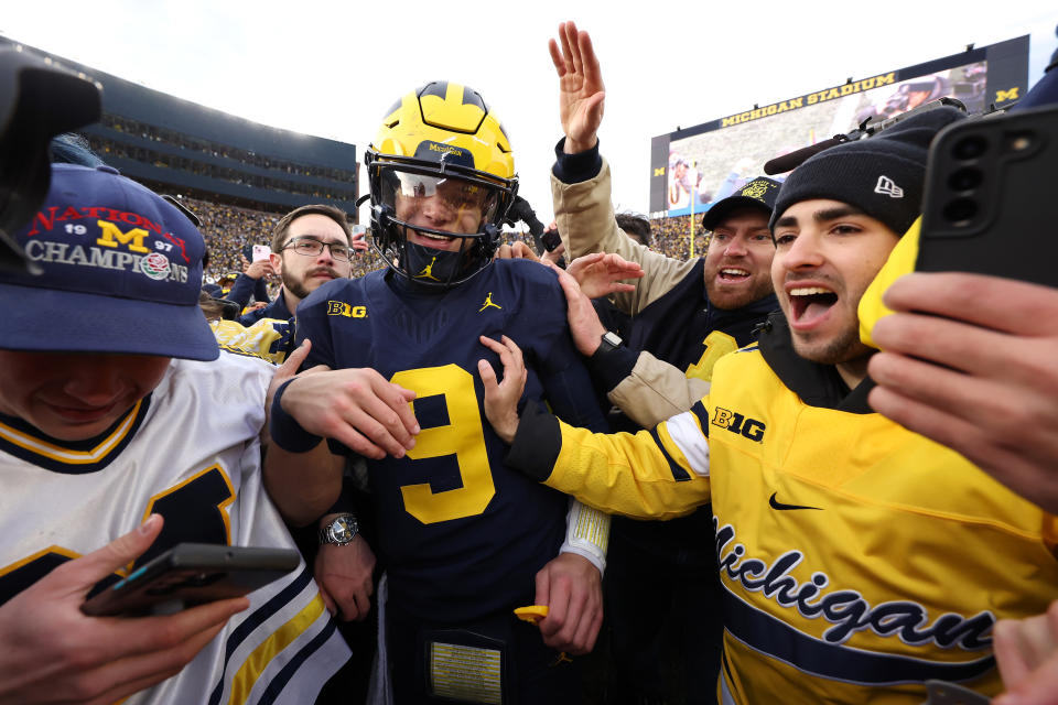 Michigan quarterback J.J. McCarthy celebrates with fans on the field after defeating Ohio State on Saturday. (Ezra Shaw/Getty Images)