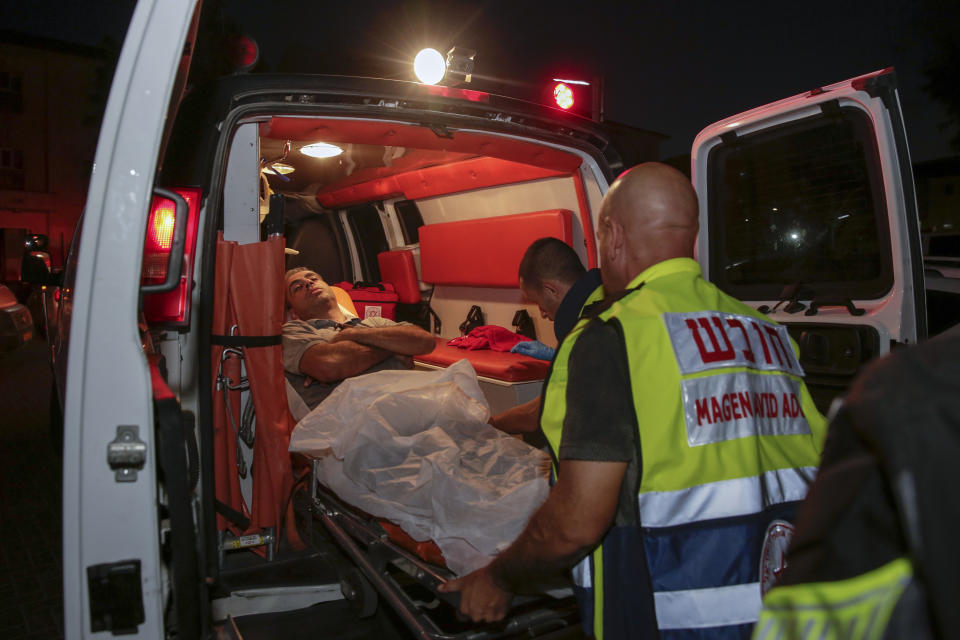 Injured person is taken to ambulance after a missile from Gaza Strip hit in the town of Sderot, Israel, Wednesday, Aug. 7, 2018. Sirens wailed in southern Israel warning of incoming projectiles from Gaza and Israeli media reported two people were lightly injured from shrapnel in the border town of Sderot. (AP photo/Yehuda Peretz)