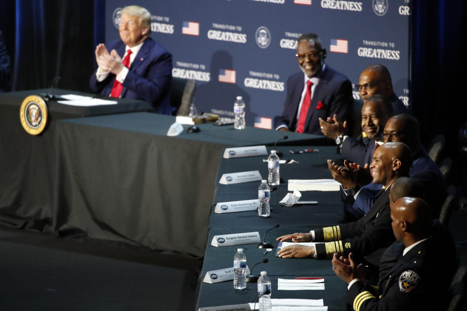 President Donald Trump applauds as U.S. Surgeon General Jerome Adams speaks during a roundtable discussion about "Transition to Greatness: Restoring, Rebuilding, and Renewing," at Gateway Church Dallas, Thursday, June 11, 2020, in Dallas.(AP Photo/Alex Brandon)