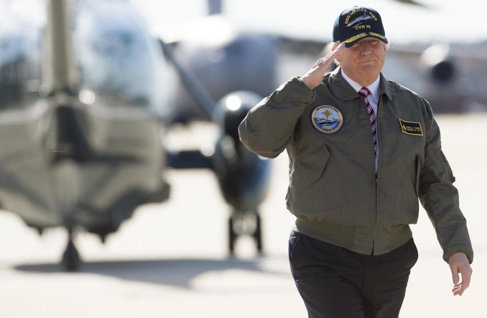 US President Donald Trump salutes as he walks to Air Force One prior to departing from Langley Air Force Base: SAUL LOEB/AFP/Getty Images