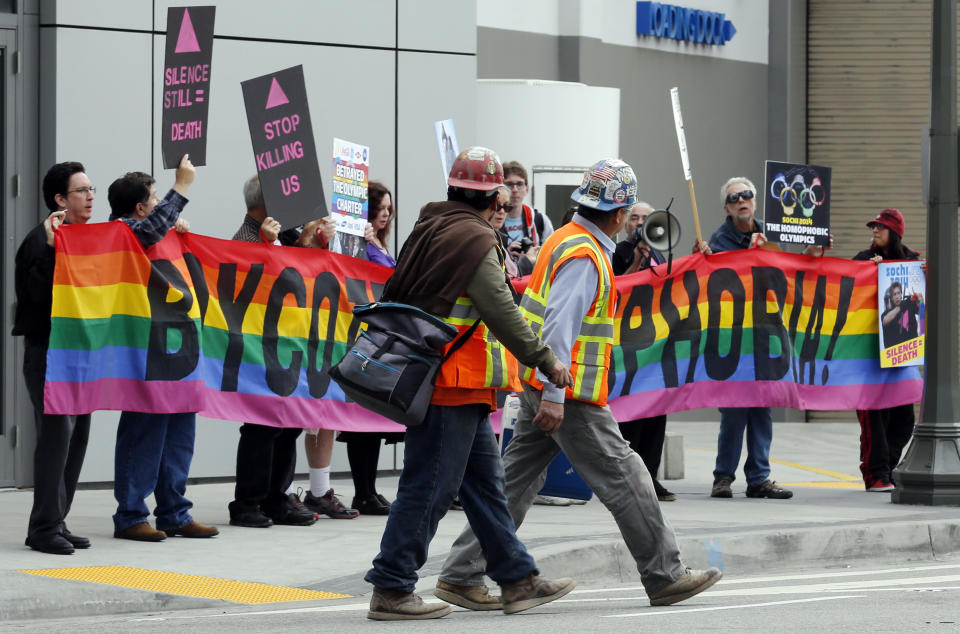 Demonstrators from a coalition of gay rights organizations, religious and political groups protest the treatment of gays in Russia, whose coastal city of Sochi hosts the 22nd Olympic Winter Games, outside the final stop of the "Road to Sochi," a traveling exhibit hosted by the U.S. Olympic Committee, at LALive in downtown Los Angeles Friday, Feb. 7, 2014. (AP Photo/Reed Saxon)