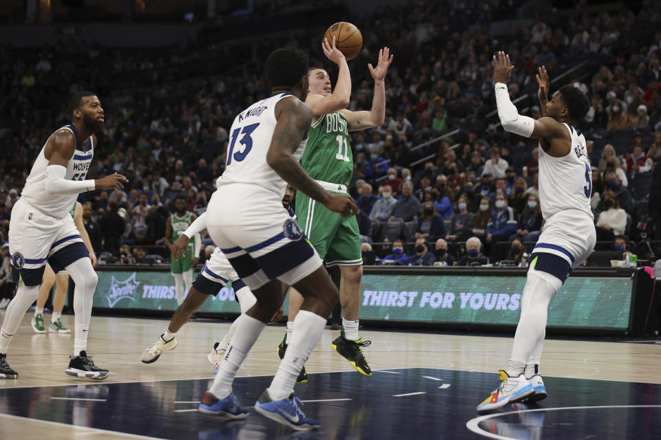 Boston Celtics guard Payton Pritchard (11) shoots against the Minnesota Timberwolves during the first half of an NBA basketball game Monday, Dec. 27, 2021, in Minneapolis. (AP Photo/Stacy Bengs)