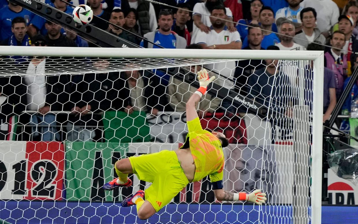 Gianluigi Donnarumma makes a flying save to deny Fabian Ruiz.