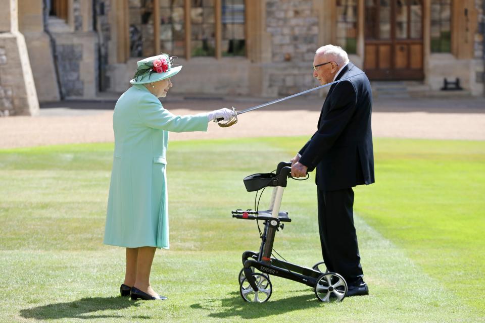 Queen Elizabeth II awards Captain Sir Thomas Moore with the insignia of Knight Bachelor at Windsor Castle on July 17, 2020.