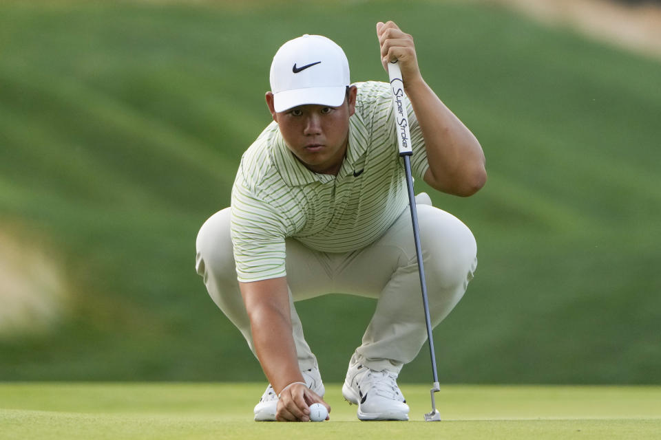 Tom Kim lines up a shot on the 12th green during the third round of the Travelers Championship golf tournament at TPC River Highlands, Saturday, June 22, 2024, in Cromwell, Conn. (AP Photo/Seth Wenig)