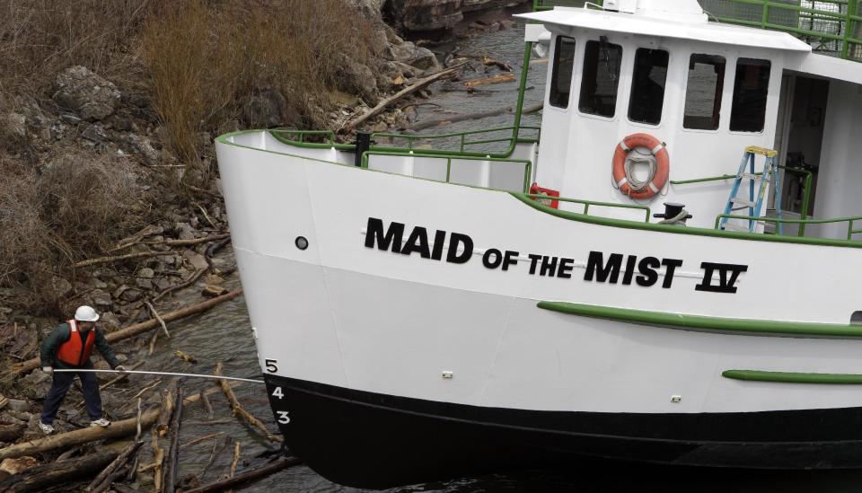 FILE - In this April 27, 2011 file photo, workers launch The Maid of the Mist tour boat in preparation for the upcoming tourist season in Niagara Falls, Ontario. The tour company chosen to take over the Niagara Falls tour boat business in Canada says it plans to build customized new boats and upgrade amenities while maintaining the things that have made the sightseeing rides so popular for more than 100 years. (AP Photo/David Duprey, File)