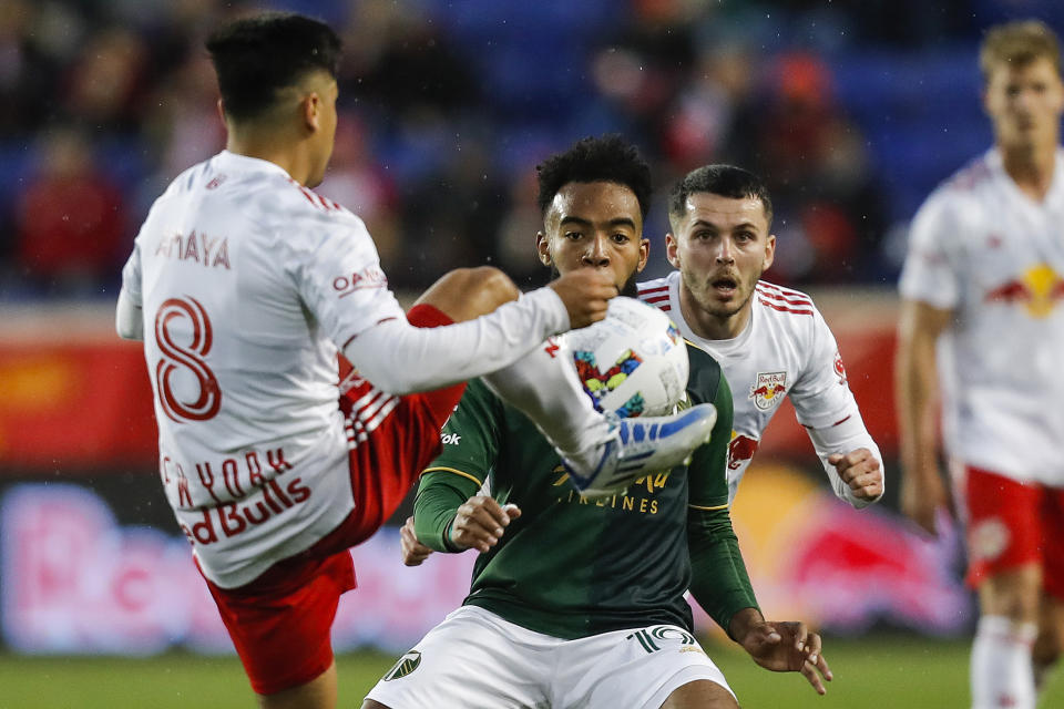 New York Red Bulls midfielder Frankie Amaya (8), left, fights for the ball against Portland Timbers midfielder Eryk Williamson (19) during the first half of an MLS soccer match, Saturday, May 7, 2022, in Harrison, N.J. (AP Photo/Eduardo Munoz Alvarez)