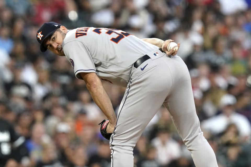 Houston Astros starting pitcher Justin Verlander checks the runner at first during the second inning of the team's baseball game against the Chicago White Sox on Tuesday, Aug. 16, 2022, in Chicago. (AP Photo/Charles Rex Arbogast)